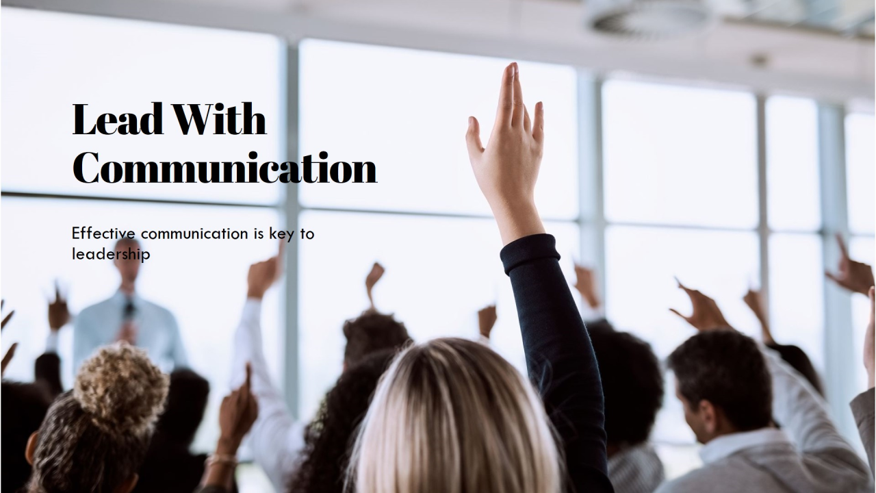 A room of raised hands at a leadership session, titled Lead With Communication