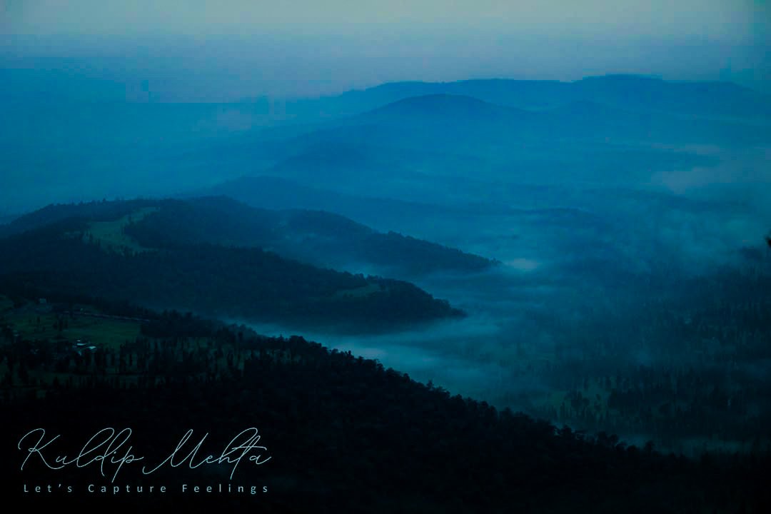 Layered hills under morning mist