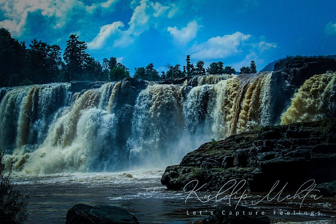 A wide waterfall in full monsoon flow